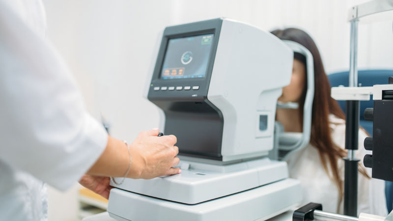 Computer diagnostics of vision, professional choice of eyeglasses. Eyesight test in optician cabinet. Patient and doctor, eye care consultation, glasses diopter selection