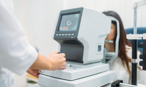 Computer diagnostics of vision, professional choice of eyeglasses. Eyesight test in optician cabinet. Patient and doctor, eye care consultation, glasses diopter selection